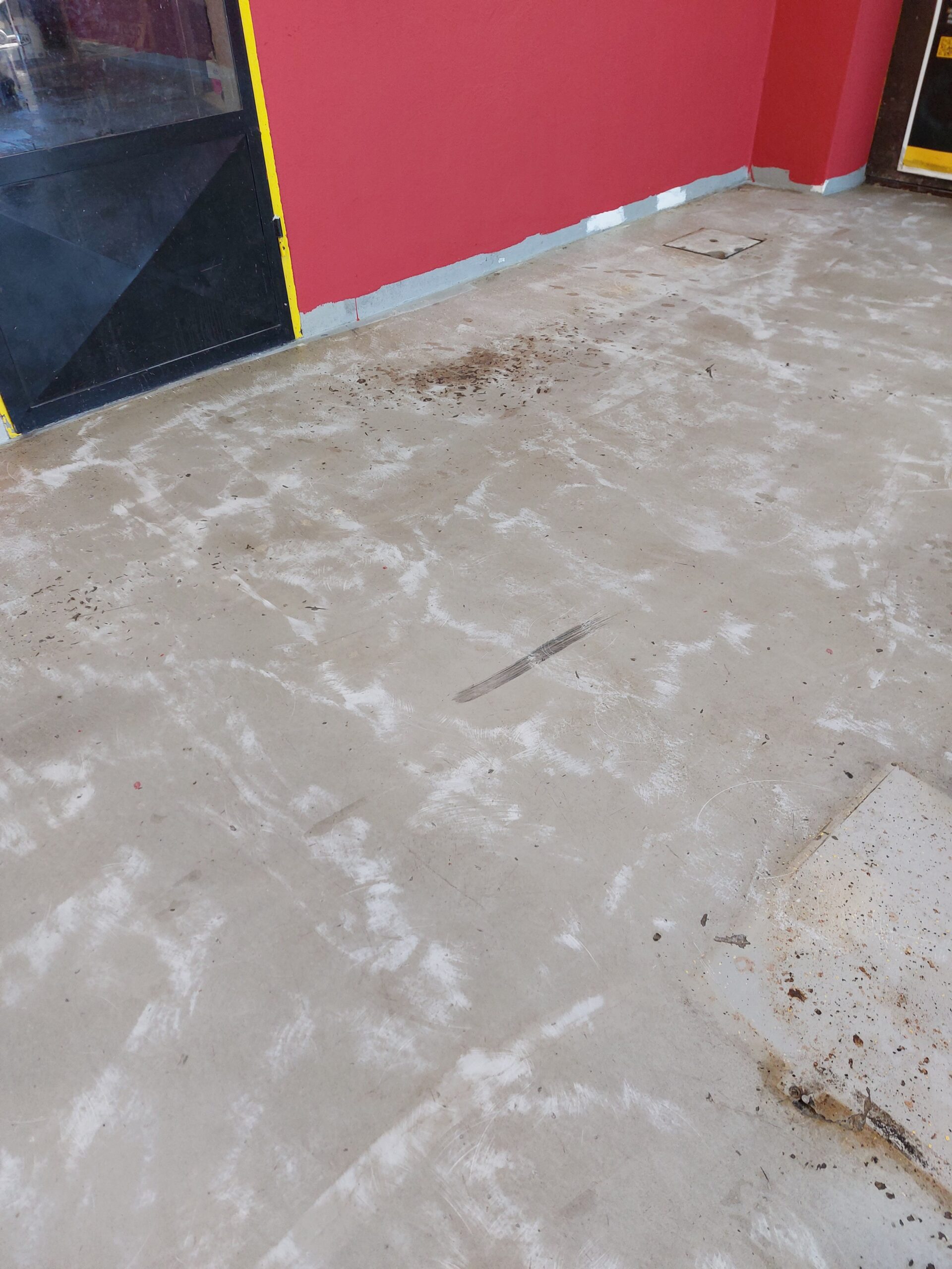 Celotna površina avtomehanične delavnice z novo pobarvanimi betonskimi tlemi
